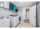 Well-organized laundry room with modern washer and dryer, sink, storage shelf, and easy access to other rooms at 12634 Mustard Seed Ct, Fishers, IN 46038