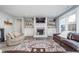 Spacious living room with fireplace, built-in shelves, stylish rug, and a cozy seating area at 12634 Mustard Seed Ct, Fishers, IN 46038