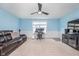 Cozy living room with a leather sofa, accent chairs, and a mounted television at 12634 Mustard Seed Ct, Fishers, IN 46038