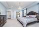 Bright main bedroom showcasing a luxurious bed, chandelier, and ensuite bathroom at 12634 Mustard Seed Ct, Fishers, IN 46038
