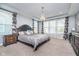Spacious main bedroom with tray ceiling, chandelier, large windows, and floral curtains at 12634 Mustard Seed Ct, Fishers, IN 46038