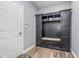 Functional mudroom area with built-in storage, bench, and convenient access to the entrance at 12634 Mustard Seed Ct, Fishers, IN 46038