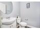 Chic powder room featuring a pedestal sink, modern fixtures, and stylish decorative touches at 12634 Mustard Seed Ct, Fishers, IN 46038
