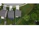 Aerial view of a home with a well-kept lawn, white privacy fence, and mature trees at 1336 Danielle Rd, Lebanon, IN 46052
