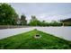 Large fenced backyard featuring a well-maintained lawn, privacy fence and a built-in fire pit at 1336 Danielle Rd, Lebanon, IN 46052