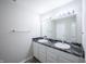 Bathroom features a double sink vanity with dark counters, tile flooring, and a large mirror with lighting at 1336 Danielle Rd, Lebanon, IN 46052
