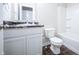 Bathroom features a white vanity with dark counters, tile flooring, toilet, and shower with tub at 1336 Danielle Rd, Lebanon, IN 46052