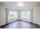 Bright bedroom features hardwood floors, white walls, and large windows with elegant white curtains at 1336 Danielle Rd, Lebanon, IN 46052