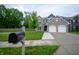 Attractive two-story home features a double garage, gray brick, and landscaped front yard at 1336 Danielle Rd, Lebanon, IN 46052