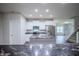 Open kitchen with granite countertops, stainless steel appliances, and seamless flow to living area at 1336 Danielle Rd, Lebanon, IN 46052