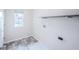 Bright laundry room with gray vinyl flooring, a wooden shelf and connections for washer and dryer at 1336 Danielle Rd, Lebanon, IN 46052
