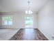 Bright living room featuring hardwood floors, neutral paint, sliding glass doors and modern light fixture at 1336 Danielle Rd, Lebanon, IN 46052