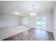 Bright living room featuring hardwood floors, neutral paint, sliding glass doors and modern light fixture at 1336 Danielle Rd, Lebanon, IN 46052