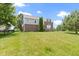 Brick home's expansive backyard with lush green lawn and beautiful landscaping, perfect for relaxation and recreation at 13624 Alston Dr, Fishers, IN 46037
