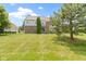 Brick home's spacious backyard with lush green lawn and beautiful landscaping, perfect for outdoor activities at 13624 Alston Dr, Fishers, IN 46037