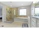 A bathroom features a shower, a bathtub, granite countertops and modern fixtures at 13624 Alston Dr, Fishers, IN 46037