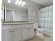 Bathroom with granite countertops, white cabinets, large mirror, and a striped shower curtain at 13624 Alston Dr, Fishers, IN 46037