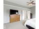 A spacious bedroom features a ceiling fan and a wooden dresser with a mounted television at 13624 Alston Dr, Fishers, IN 46037