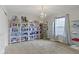 Bedroom with carpet, chandelier and built in shelving with glass doors at 13624 Alston Dr, Fishers, IN 46037