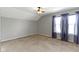 A bedroom features tan carpet and curtains at 13624 Alston Dr, Fishers, IN 46037