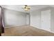 A bedroom with plush tan carpet and two doors at 13624 Alston Dr, Fishers, IN 46037