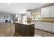 Bright kitchen featuring a center island, granite countertops, white cabinets, and seamless connection to the living area at 13624 Alston Dr, Fishers, IN 46037