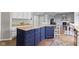Modern kitchen island with granite countertops, contrasting dark cabinetry, and bar stool seating for casual dining at 13624 Alston Dr, Fishers, IN 46037