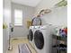 Efficient laundry room with modern washer and dryer, ample storage space, and natural light at 13624 Alston Dr, Fishers, IN 46037