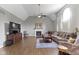 Open concept living room featuring a fireplace, ceiling fan, and ample seating at 13624 Alston Dr, Fishers, IN 46037