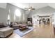 Open-concept living room with hardwood floors flowing into a modern kitchen at 13624 Alston Dr, Fishers, IN 46037