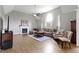 Bright living room with hardwood floors, fireplace, ceiling fan, and large arched windows at 13624 Alston Dr, Fishers, IN 46037