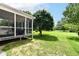 Exterior of the home, including screened in porch and spacious green backyard at 13700 Stanford Dr, Carmel, IN 46074