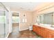 Bathroom with dual sinks, wood cabinets, tiled floors, and a glass-enclosed shower at 13700 Stanford Dr, Carmel, IN 46074