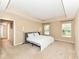 Spacious bedroom with tray ceiling, two windows, and a comfortable queen bed at 13700 Stanford Dr, Carmel, IN 46074