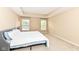 Bright bedroom with tray ceilings, two windows, and a cozy queen-sized bed at 13700 Stanford Dr, Carmel, IN 46074