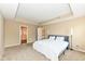 Large bedroom with a tray ceiling and neutral carpet, next to an ensuite bath at 13700 Stanford Dr, Carmel, IN 46074