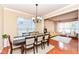 Elegant dining room with a stylish chandelier and large window, seamlessly connected to the cozy living room at 13700 Stanford Dr, Carmel, IN 46074