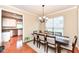 Traditional dining room featuring a chandelier, table with seating for six and view into the kitchen at 13700 Stanford Dr, Carmel, IN 46074