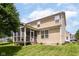 Back of home with screened porch, yard, and neutral siding at 13700 Stanford Dr, Carmel, IN 46074