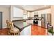 Spacious kitchen featuring stainless steel appliances, dark countertops and white cabinetry at 13700 Stanford Dr, Carmel, IN 46074