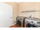 Laundry room with side-by-side washer and dryer and wire shelving at 13700 Stanford Dr, Carmel, IN 46074