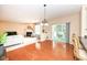 Open-concept living and dining space with sliding glass door and brick fireplace at 13700 Stanford Dr, Carmel, IN 46074