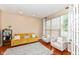 Cozy living room featuring a comfortable yellow sofa, two chairs, and lots of natural light at 13700 Stanford Dr, Carmel, IN 46074