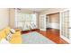 Comfortable living room featuring a cozy yellow sofa, chairs, French doors, and beautiful hardwood floors at 13700 Stanford Dr, Carmel, IN 46074