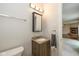 Bathroom featuring vanity with granite countertop and a view of the living room at 14523 Lee Stewart Ln, Fishers, IN 46038
