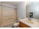 Bright bathroom features a shower and tub combination, a sink with wood cabinets, and a large mirror at 14523 Lee Stewart Ln, Fishers, IN 46038