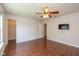 Spacious bedroom with hardwood floors, ceiling fan, and ensuite access at 14523 Lee Stewart Ln, Fishers, IN 46038
