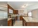 Well-lit kitchen featuring stainless steel appliances, custom cabinets, and an island with granite countertop at 14523 Lee Stewart Ln, Fishers, IN 46038