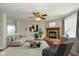 Elegant living room featuring a modern fireplace, stylish furnishings, and an abundance of natural light at 14523 Lee Stewart Ln, Fishers, IN 46038