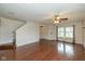 Open concept living room with hardwood floors and staircase, creating a spacious and inviting atmosphere at 14523 Lee Stewart Ln, Fishers, IN 46038